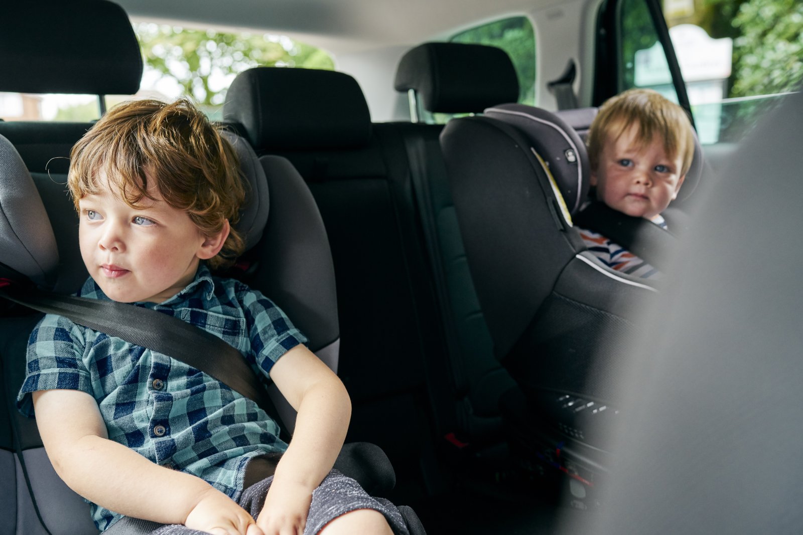 two toddlers safely buckled in car seats for a roa 2024 07 04 19 26 02 utc